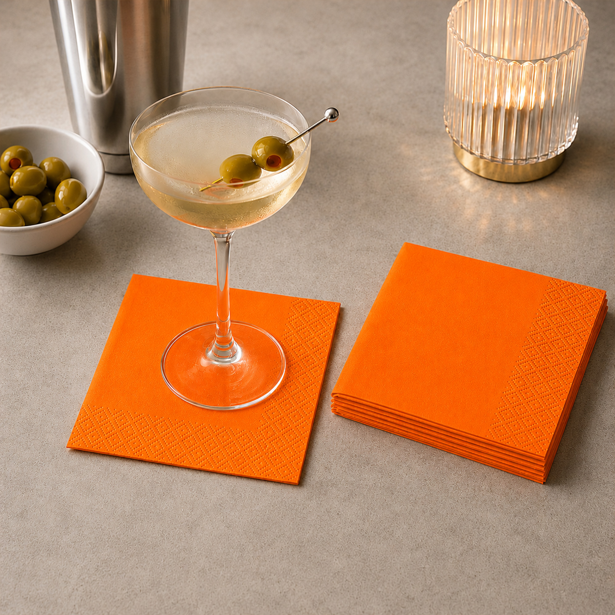 orange cocktail paper napkins styled on a party table